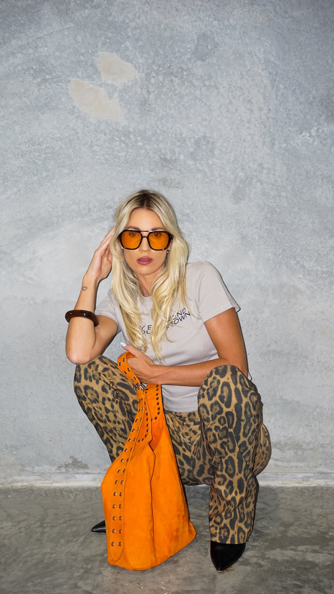 The Romy Riveted Hobo Bag in International Orange Suede